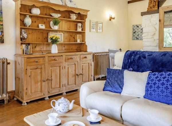 The Stable - spacious living area with wooden dresser