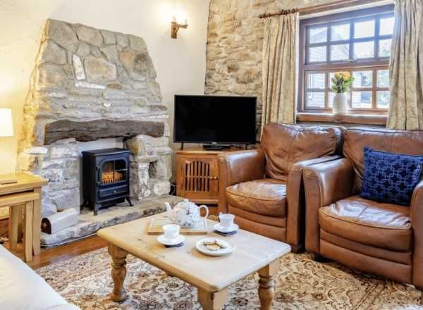 The Stable - cozy living room with stone fireplace