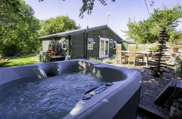 The Pendragon - exterior view with private hot tub and garden seating area